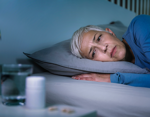 Woman lying awake in bed at night